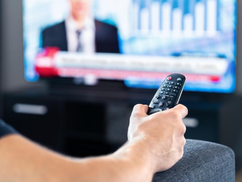 Man watching television news 