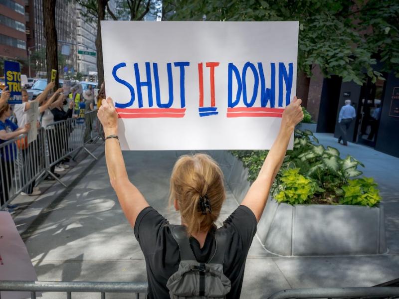 Woman holding protest sign