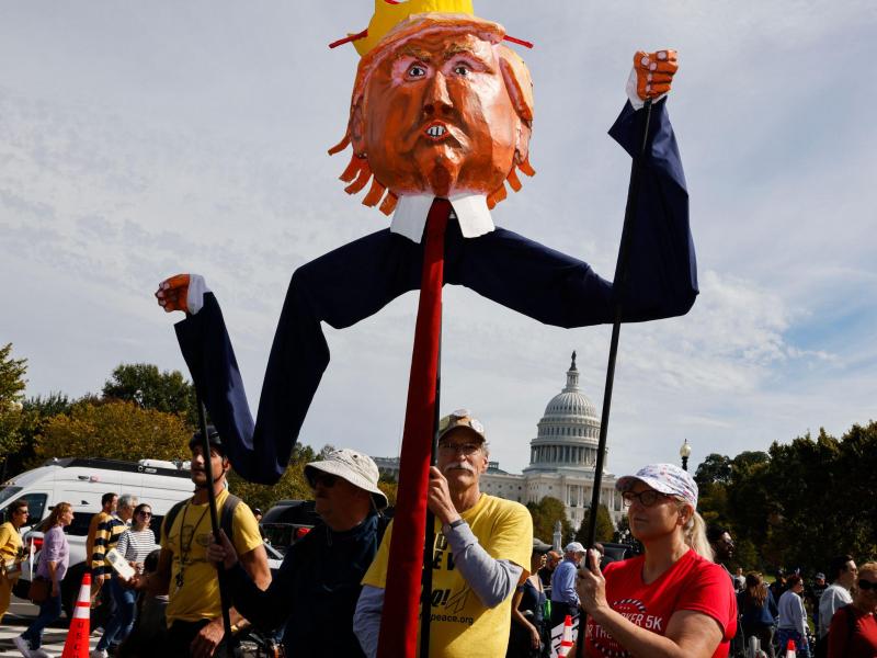 Protestors in Washington D.C. hold anti-Trump signs 
