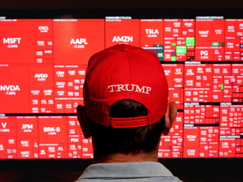 Man wearing red Trump hat watching red screen