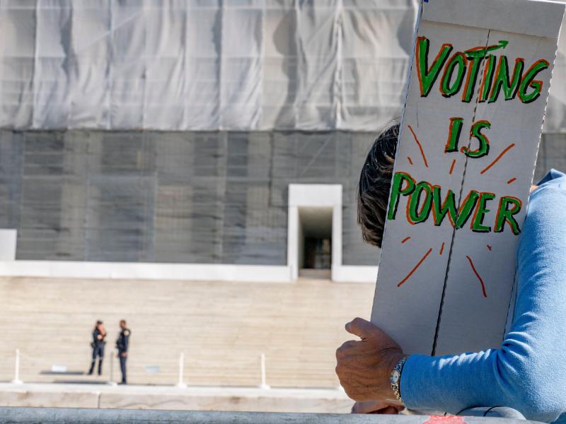A protestor rallies at the Supreme Court in support of the Voting Rights Act
