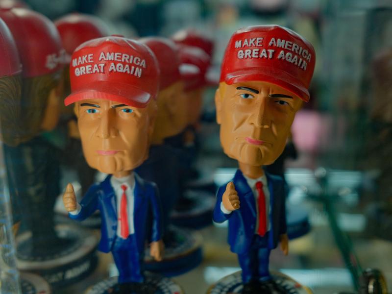Two bobblehead dolls featuring Donald Trump's face and "Make America Great Again" hats
