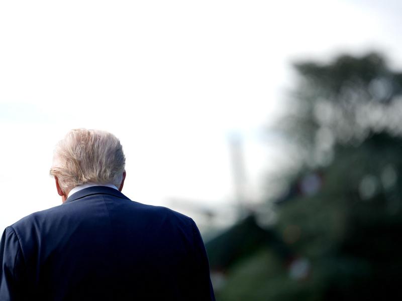 Photo looking over the back shoulder of President Donald Trump 